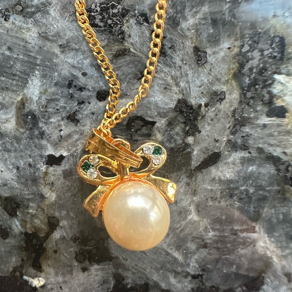 Gold necklace with bow pendant with pearl and gemstone and diamonds